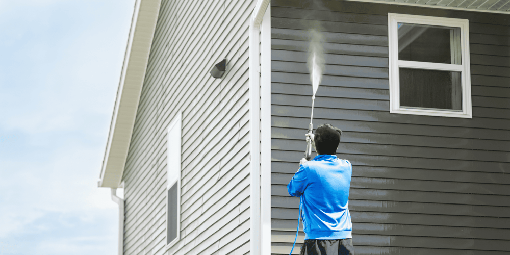 Stock Image of Person Washing James Hardie Siding