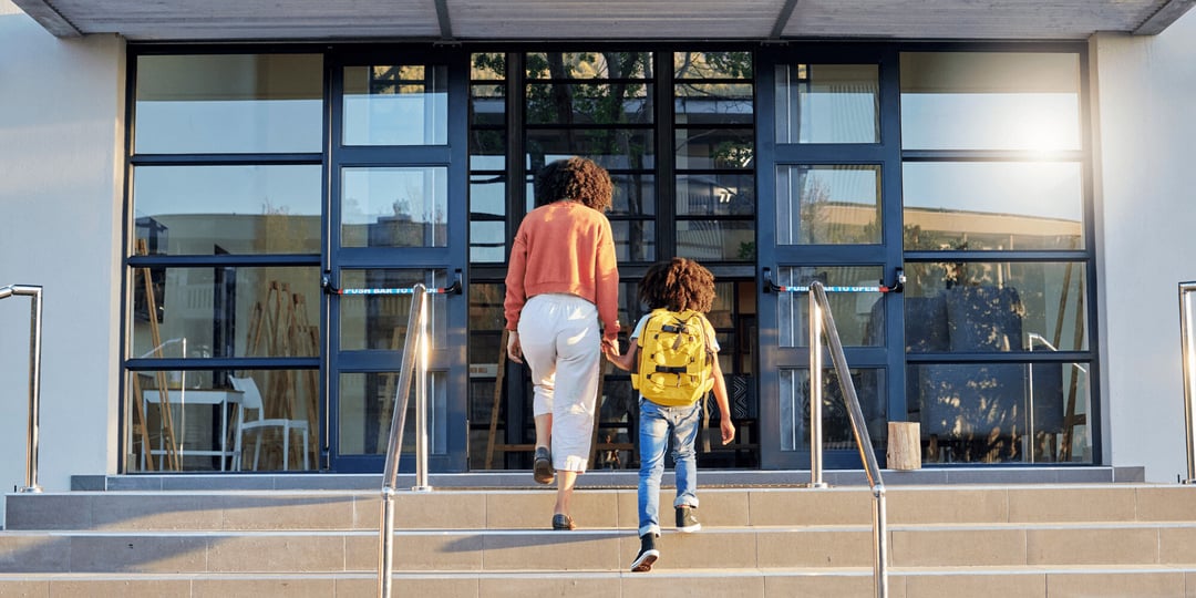 Stock Image of Mother and Child Entering School