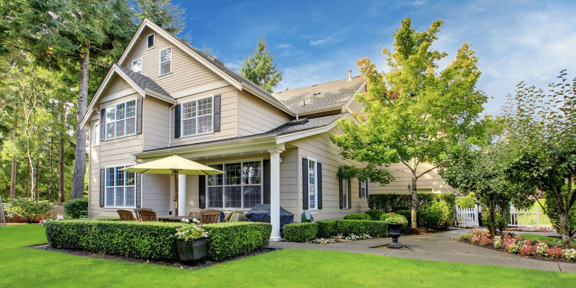 Stock Image of a Beige Home with New Windows and Shutters