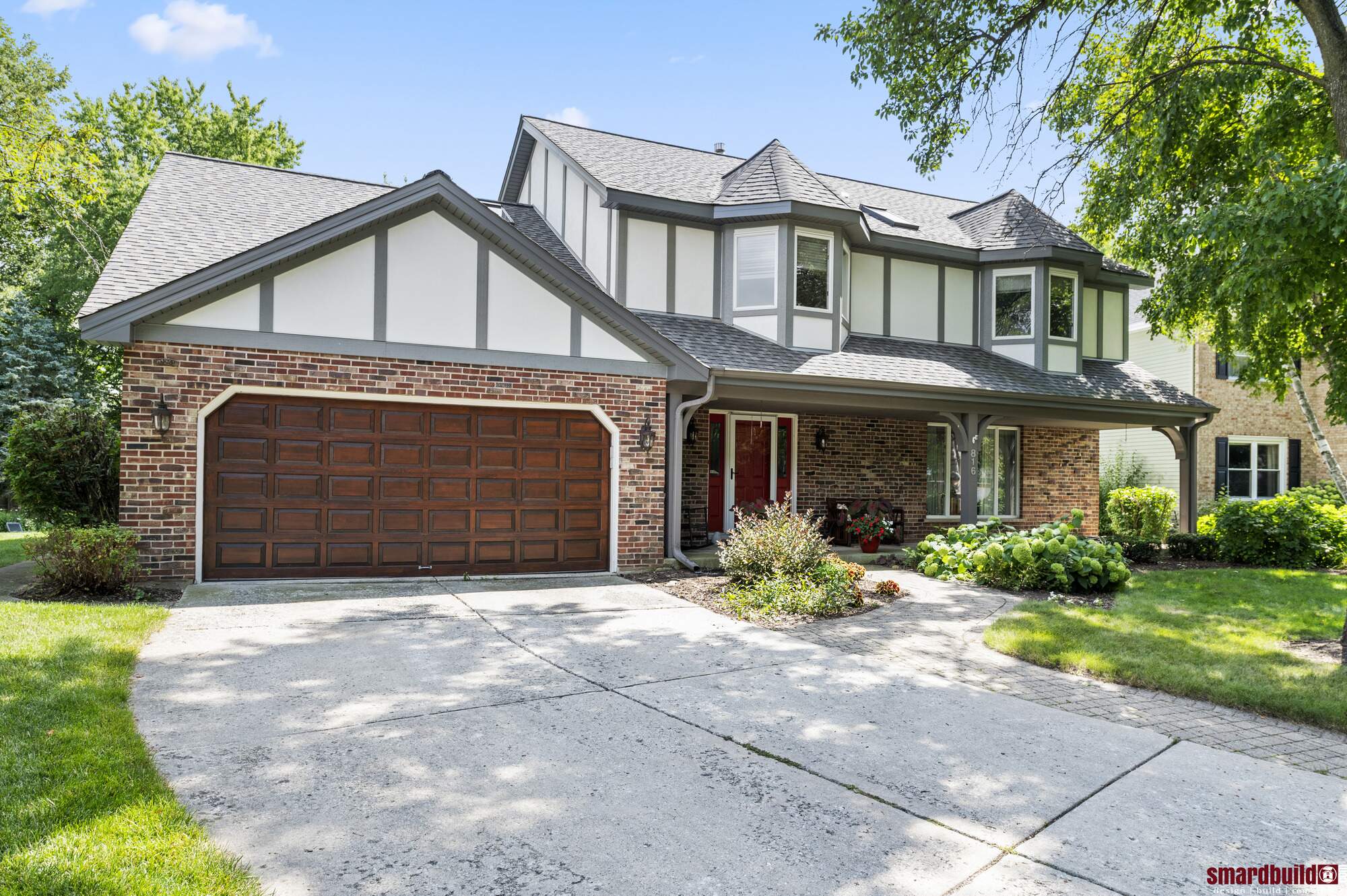 Exterior view of home with brick and white siding