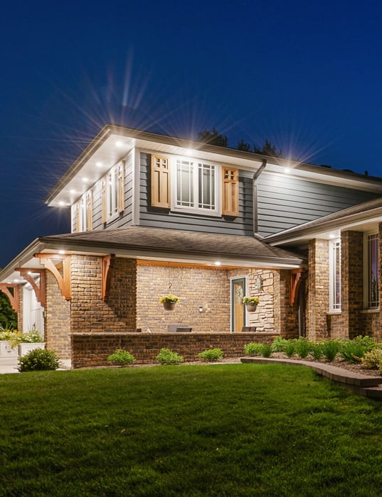 Exterior view of home with blue James Hardie siding and brick