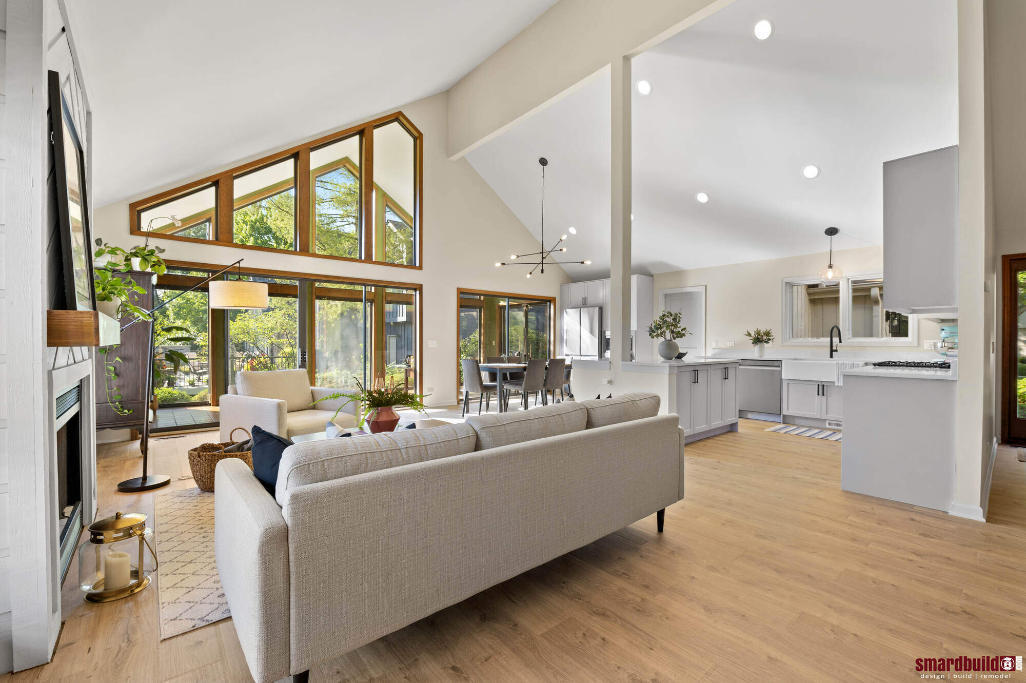 Open-concept living room with vaulted ceilings and large windows by Smardbuild in Naperville, IL