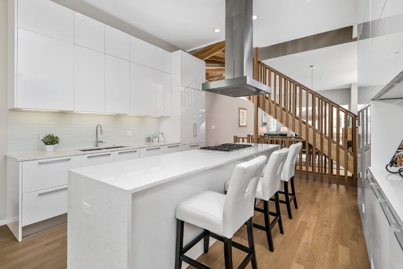 Modern all white kitchen with stove in island