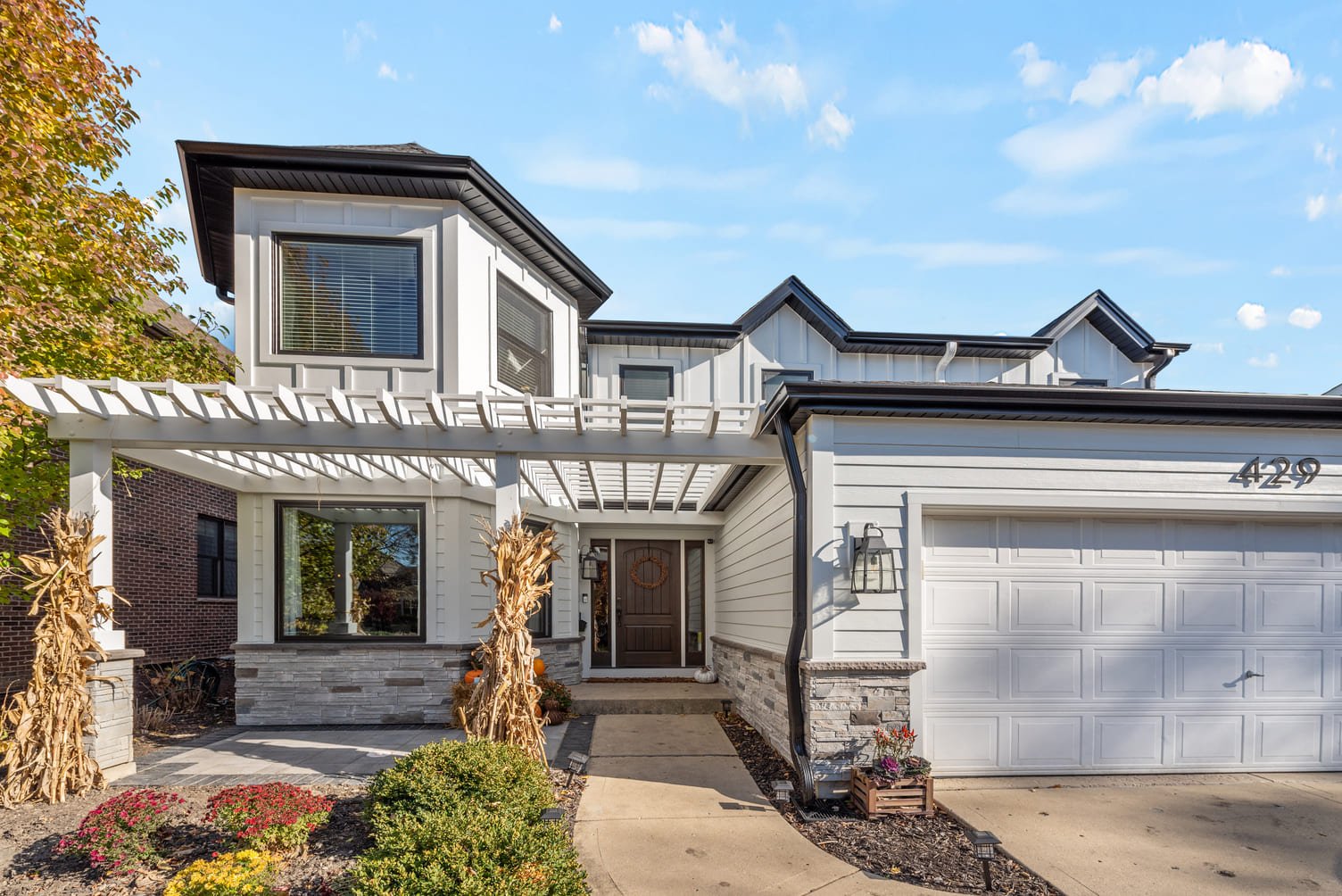 Elmhurt, Illinois, home exterior with wood pergola and white siding