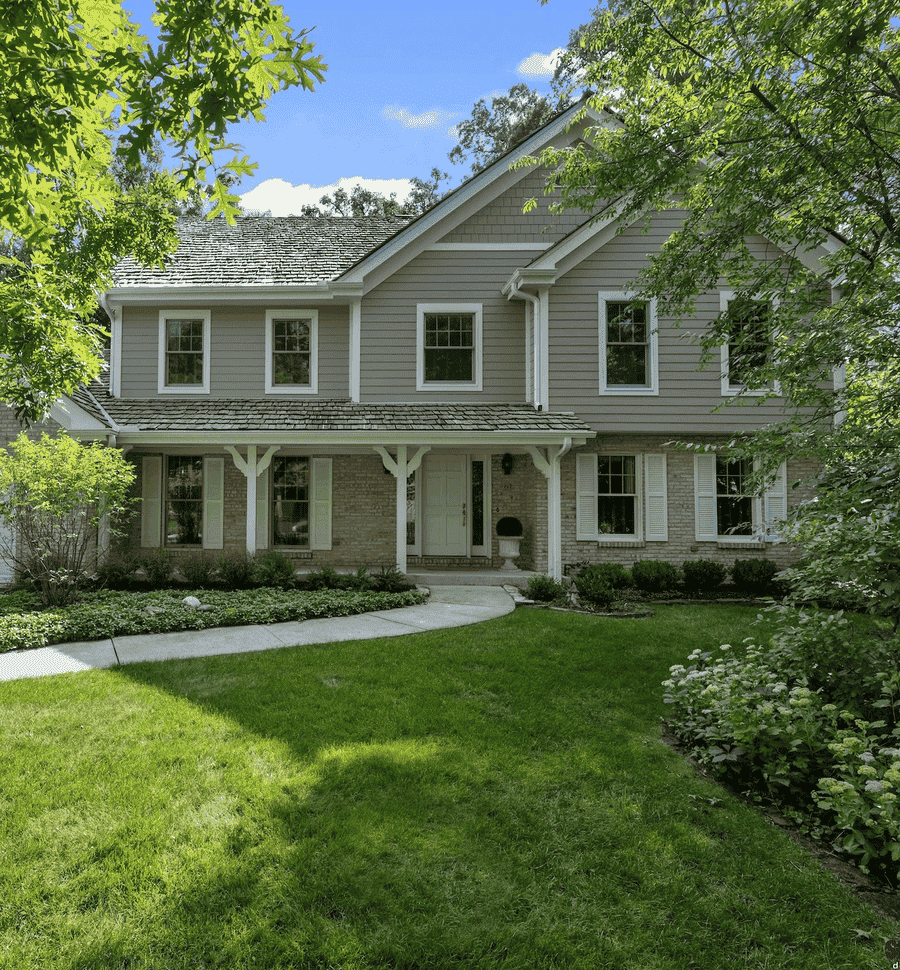 Exterior view of home with light gray siding and white trim