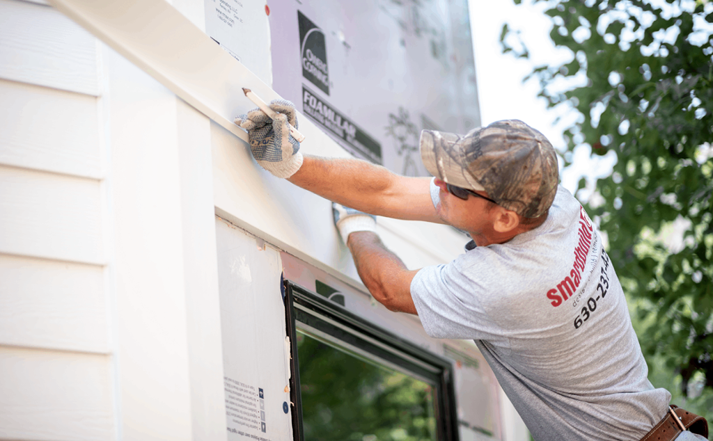 Smardbuild employee installing home exterior trim